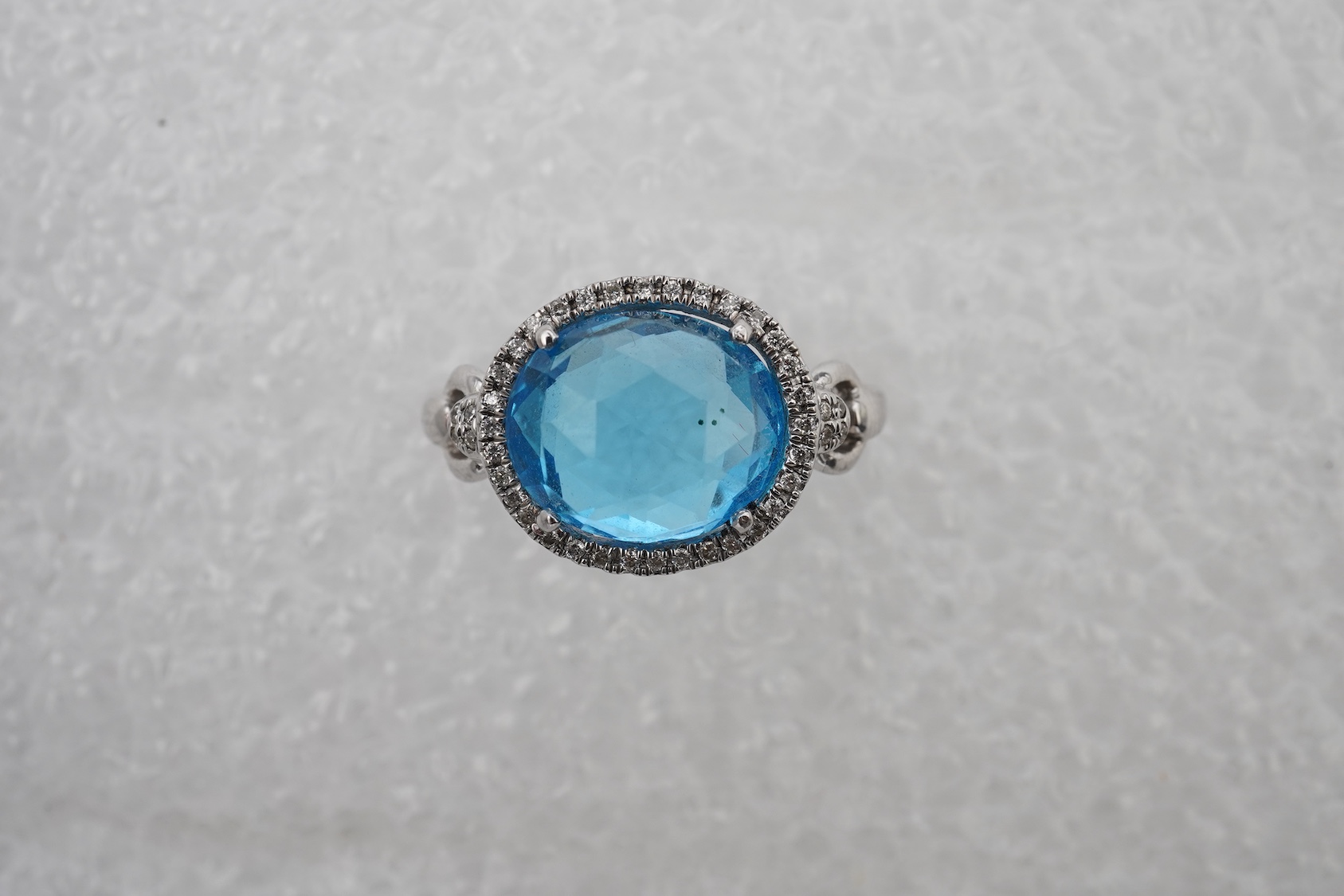 A blue topaz and diamond ring